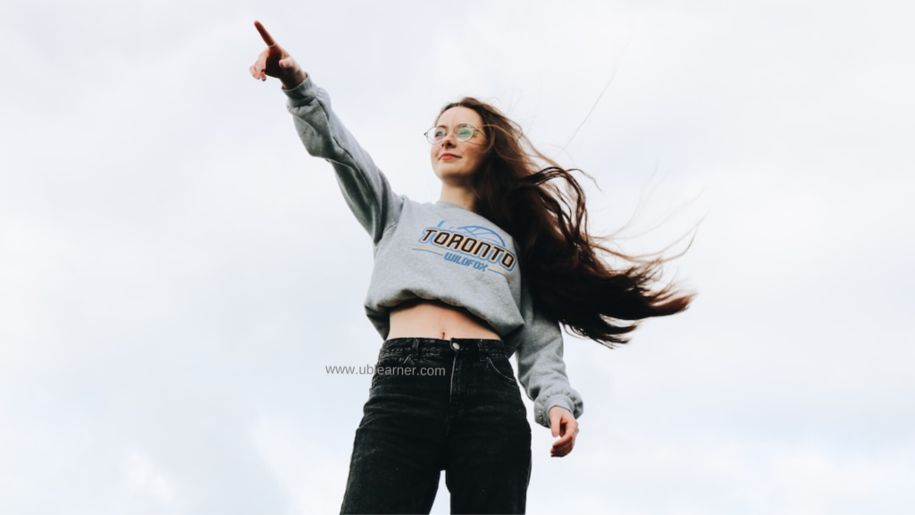 A girl pointing at the sky for her confident English